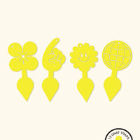 Four yellow sticky gnat traps with staked bottoms. From left to right, there is a flower shape, a pointing finger shape, a smiling sun shape, and a globe shape.