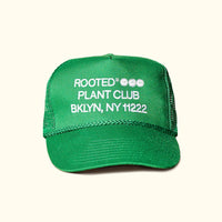 A green colored trucker hat that reads: Rooted Plant Club. BKLYN, NY 11222